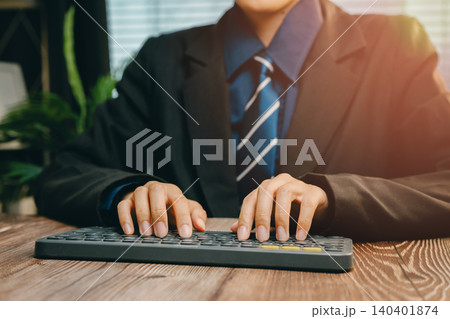 Business Professional Typing on Keyboard at Modern Workspace with Natural Light and Greenery, Business concept Business Professional Typing on Keyboard at Modern Workspace with Natural Light and Greenery, Business concept 140401874