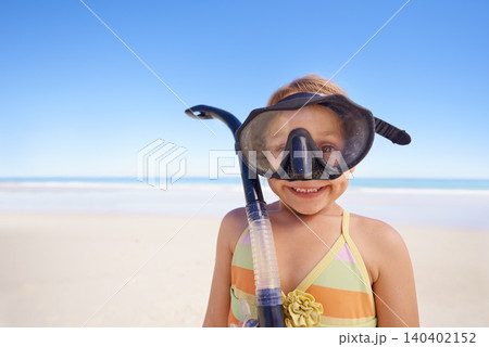 Girl, portrait and goggles for snorkeling at beach, smile and equipment for swimming on holiday. Female person, child and travel on tropical vacation in outdoors, sand and blue sky for mockup space 140402152