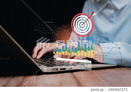 Analytics and Target concept. Focused Business Professional Using Laptop with Analytics and Target Graphics in Modern Workspace Setting Analytics and Target concept. Focused Business Professional Using Laptop with Analytics and Target Graphics in Modern Workspace Setting 140402371