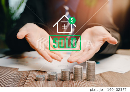Sold House Concept. Businessman Presenting Sold House Concept with Stacked Coins and Financial Symbols for Real Estate Success Sold House Concept. Businessman Presenting Sold House Concept with Stacked Coins and Financial Symbols for Real Estate Success 140402575