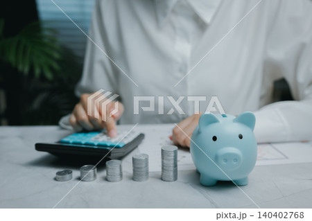 Savings strategy with calculator and piggy bank approach, Business concept Savings strategy with calculator and piggy bank approach, Business concept 140402768