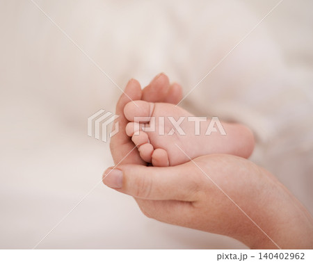 Feet, hand and parents with infant, support and love of parent for bonding or wellness. Family, close up of caring person holding baby toes for security, protection and childhood development 140402962