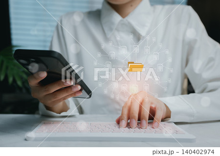 Person Using Smartphone and Computer to Manage Digital Files, business concept 140402974
