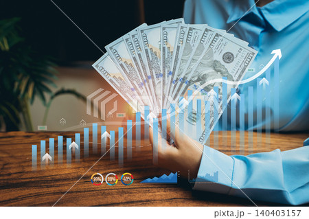 Hands Holding Currency with Financial Graphs and Positive Trends in Business Investment and Growth Concepts, Business concept Hands Holding Currency with Financial Graphs and Positive Trends in Business Investment and Growth Concepts, Business concept 140403157