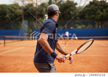 Tennis, training and man in game of sport, competition or exercise for fitness on court. Athlete, workout and play on pitch outdoor in summer with action, challenge and person in contest from back Tennis, training and man in game of sport, competition or exercise for fitness on court. Athlete, workout and play on pitch outdoor in summer with action, challenge and person in contest from back 140403216