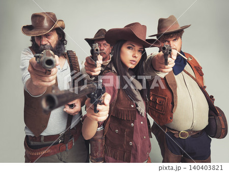 Bandit group, portrait and cowboys with weapon, aimed and Halloween on white background. Wild western, costume and characters of Texas criminals, comic and vintage for old west theme with studio gun Bandit group, portrait and cowboys with weapon, aimed and Halloween on white background. Wild western, costume and characters of Texas criminals, comic and vintage for old west theme with studio gun 140403821