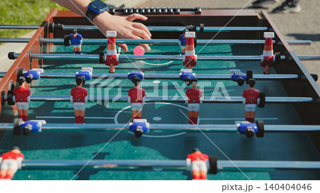 Kid playing table football during sports day Kid playing table football during sports day 140404046