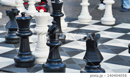 Boy playing giant chess in a park during sports day Boy playing giant chess in a park during sports day 140404056