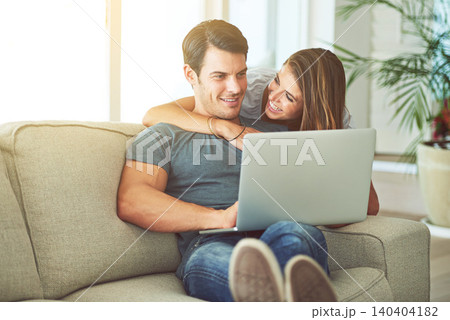 Computer, smile and woman hugging man on sofa networking on social media, website or internet. Happy, love and female person embracing husband reading online blog with laptop in living room at home. Computer, smile and woman hugging man on sofa networking on social media, website or internet. Happy, love and female person embracing husband reading online blog with laptop in living room at home. 140404182
