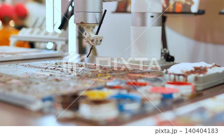 Robot painting on palette, creating art at a technology exhibition Robot painting on palette, creating art at a technology exhibition 140404183