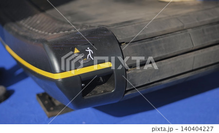 Treadmill safety warning sticker showing a person falling with a danger sign Treadmill safety warning sticker showing a person falling with a danger sign 140404227