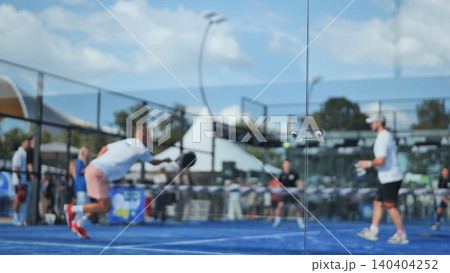 Padel players hitting the ball during a competitive game on an outdoors court 140404252