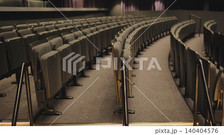 Empty cinema hall preparing for a movie or presentation Empty cinema hall preparing for a movie or presentation 140404576