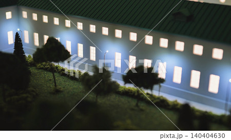 Architectural model of a building at night with glowing windows and street lighting Architectural model of a building at night with glowing windows and street lighting 140404630