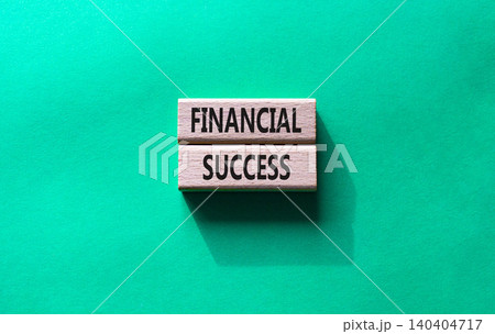 Financial success symbol. Concept word Financial success on wooden blocks. Beautiful green background. Business and Financial success concept. Copy space Financial success symbol. Concept word Financial success on wooden blocks. Beautiful green background. Business and Financial success concept. Copy space 140404717