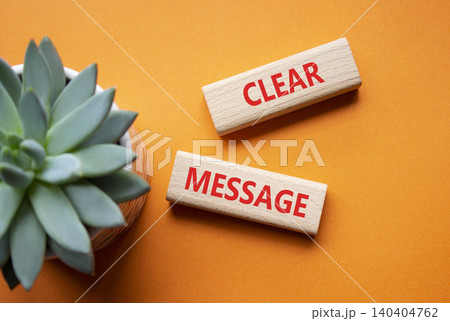 CLEAR MESSAGE symbol. Concept word CLEAR MESSAGE on wooden blocks. Beautiful orange background with succulent plant. Business and CLEAR MESSAGE concept. Copy space 140404762