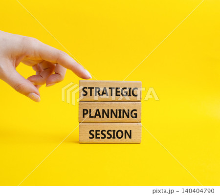 Strategic Planning Session symbol. Concept word Strategic Planning Session on wooden blocks. Businessman hand. Beautiful yellow background. Business and Strategic Planning Session. Copy space Strategic Planning Session symbol. Concept word Strategic Planning Session on wooden blocks. Businessman hand. Beautiful yellow background. Business and Strategic Planning Session. Copy space 140404790