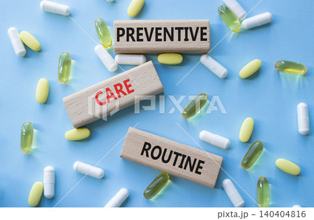Preventive care routine symbol. Concept words Preventive care routine on wooden blocks. Beautiful blue background with pills. Healthcare and Preventive care routine concept. Copy space. 140404816