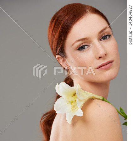 Portrait, skincare and woman with flower, lily and natural beauty isolated on a gray studio background mockup. Face, organic and ginger model with floral cosmetics for glow, wellness and makeup Portrait, skincare and woman with flower, lily and natural beauty isolated on a gray studio background mockup. Face, organic and ginger model with floral cosmetics for glow, wellness and makeup 140404827