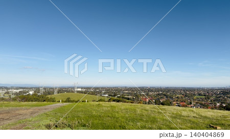 Electrical power grid pylons and cables running through agricultural green fields. Overview of public utilities infrastructure development under a bright sunny autumn sky in Melbourne, Australia. Electrical power grid pylons and cables running through agricultural green fields. Overview of public utilities infrastructure development under a bright sunny autumn sky in Melbourne, Australia. 140404869