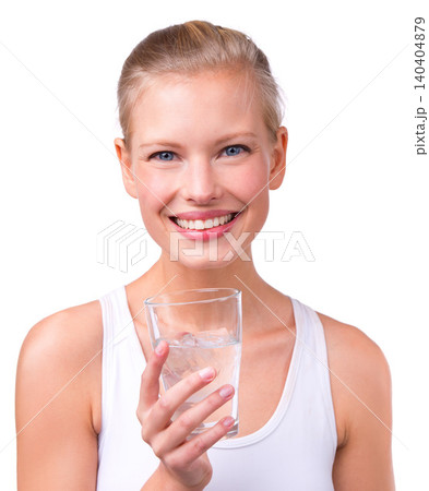 Portrait, woman and health with water glass, smile and happy on white background. Young female, nutrition and wellness goals in studio for hydrate, refresh and thirst for detox and happiness 140404879