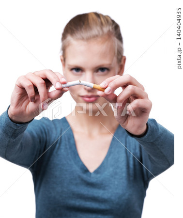 Studio, portrait and woman with broken cigarette to quit tobacco for health, wellness and results. White background, girl and stop smoking for healthcare benefits, commitment and addiction support. Studio, portrait and woman with broken cigarette to quit tobacco for health, wellness and results. White background, girl and stop smoking for healthcare benefits, commitment and addiction support. 140404935