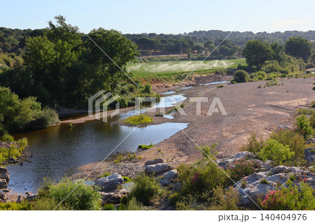 Agricultural irrigation next to a dry riverbed during drought at Ribeira da Raia, Acude do Furadouro. Agricultural irrigation next to a dry riverbed during drought at Ribeira da Raia, Acude do Furadouro. 140404976