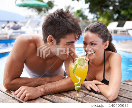 Swimming pool, cocktail and couple with holiday, sunshine and weekend break with happiness, relax and honeymoon. Summer, man or woman with tropical drink or wet with getaway trip or luxury with water 140405085