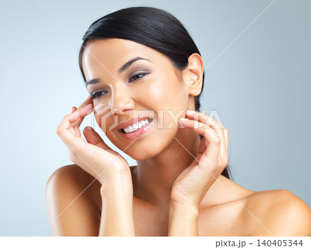 Cosmetics, shine and woman with dermatology, glow and wellness on a grey studio background. Person, model and girl with beauty and healthy skin with grooming and skincare with aesthetic and makeup Cosmetics, shine and woman with dermatology, glow and wellness on a grey studio background. Person, model and girl with beauty and healthy skin with grooming and skincare with aesthetic and makeup 140405344