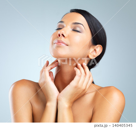 Glow, shine and woman with cosmetics, dermatology and wellness on grey studio background. Person, model and girl with grooming or healthy skin with beauty or facial with makeup, aesthetic or skincare 140405345