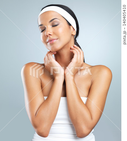 Young woman, beauty and skincare in studio background smile, happy and proud with headband. Female model, makeup and cosmetics for work with confidence, satisfaction and pride with eyes closed 140405410