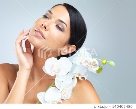 Flowers, skincare and woman with beauty, wellness and person on grey studio background. Model, luxury and girl with aesthetic and cosmetics with facial or shine with glow, dermatology and smooth skin Flowers, skincare and woman with beauty, wellness and person on grey studio background. Model, luxury and girl with aesthetic and cosmetics with facial or shine with glow, dermatology and smooth skin 140405480