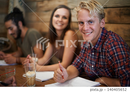 Portrait, student and happy man writing at coffee shop, learning and friends studying together in university. Face, group and education at cafe for college exam, test and collaboration with diversity Portrait, student and happy man writing at coffee shop, learning and friends studying together in university. Face, group and education at cafe for college exam, test and collaboration with diversity 140405652