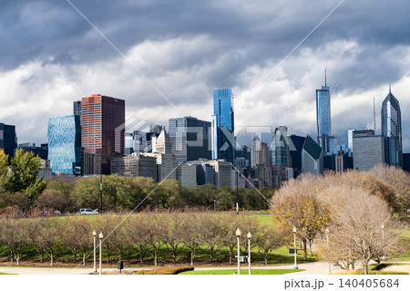 City skyscraper. Business skyscraper building. Urban skyline and autumn park. Architectural building business district. Park and skyscraper cityscape. Iconic skyline landmark. Architecture building 140405684