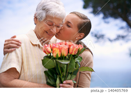 Senior woman, daughter and kiss with flowers, hug and care for love, bonding and reunion at family home. People, elderly mom and mothers day celebration with connection, gift and bouquet in garden Senior woman, daughter and kiss with flowers, hug and care for love, bonding and reunion at family home. People, elderly mom and mothers day celebration with connection, gift and bouquet in garden 140405769
