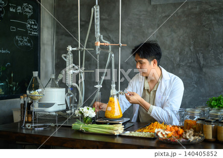 Young Asian Scientist Distilling Herbal Botanical Extracts in Laboratory with Natural Ingredients 140405852