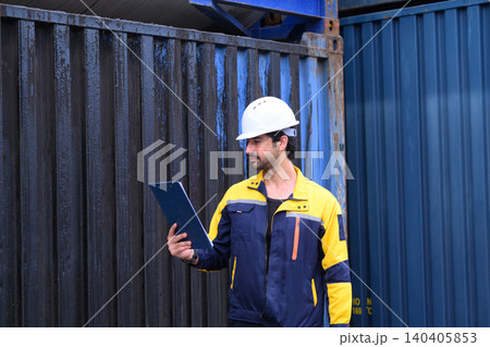 Logistics inspector checking shipping containers at industrial cargo terminal Logistics inspector checking shipping containers at industrial cargo terminal 140405853