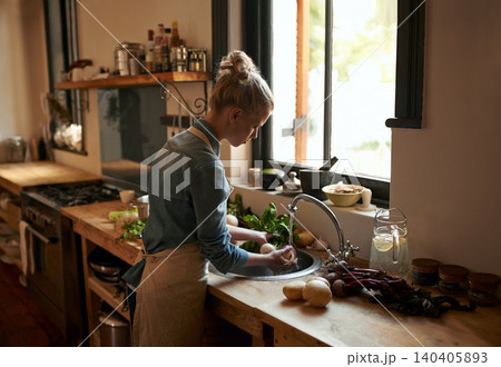 Woman, chef and washing food for hygiene in the kitchen sink at home for cooking. Female person, prepare and cleaning vegetables for meal and nutrition or rising in water for a healthy diet Woman, chef and washing food for hygiene in the kitchen sink at home for cooking. Female person, prepare and cleaning vegetables for meal and nutrition or rising in water for a healthy diet 140405893