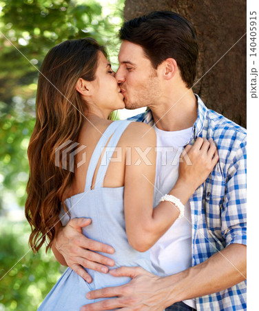Love, kiss and date with couple in park for romance, bonding and summer vacation. Happiness, commitment and relax with young man and woman hugging in nature for funny, support and relationship Love, kiss and date with couple in park for romance, bonding and summer vacation. Happiness, commitment and relax with young man and woman hugging in nature for funny, support and relationship 140405915