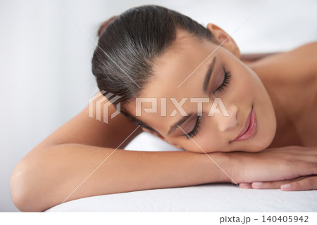 Relax, beauty and woman sleeping at spa with self care, wellness and luxury skin treatment for zen. Calm, cosmetics and young female person with body routine taking nap on towel at health salon. 140405942