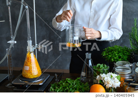 Herbalist Scientist Extracting Natural Plant Essence in Laboratory with Botanical Ingredients and Glassware 140405945