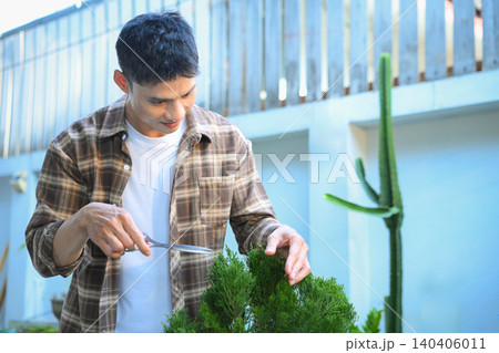 A man making bonsai pruning with precision care and craftsmanship 140406011