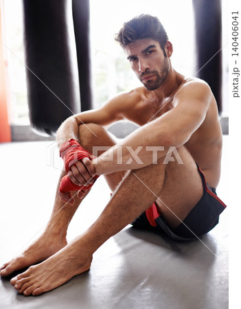 Man, portrait and boxer in gym for combat, training and determination with gloves for match. Male athlete, mma and fighter at fitness studio for practicing for competition, challenge and kickboxing Man, portrait and boxer in gym for combat, training and determination with gloves for match. Male athlete, mma and fighter at fitness studio for practicing for competition, challenge and kickboxing 140406041