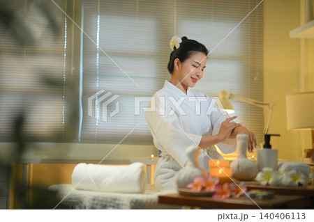 Woman applying lotion in spa room with warm light and calm wellness atmosphere Woman applying lotion in spa room with warm light and calm wellness atmosphere 140406113
