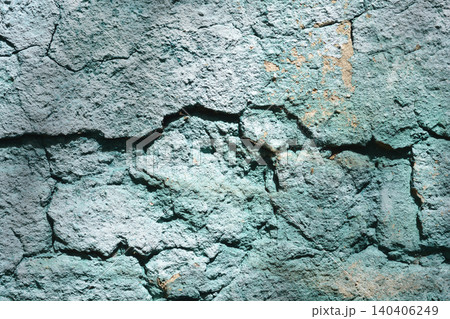 Cracked turquoise plaster on an old stone wall texture Cracked turquoise plaster on an old stone wall texture 140406249