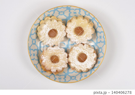 Top down view of Linzer cookies on a blue patterned plate Top down view of Linzer cookies on a blue patterned plate 140406278