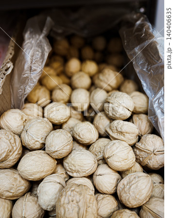 Abundant pile of fresh walnuts in rustic packaging for healthy snacking and cooking Abundant pile of fresh walnuts in rustic packaging for healthy snacking and cooking 140406635