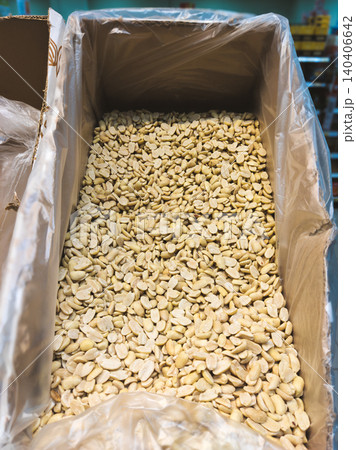 Bulk display of shelled white beans in a large bin at a market 140406642
