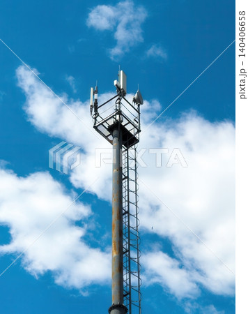 Cell tower against blue sky with clouds Cell tower against blue sky with clouds 140406658