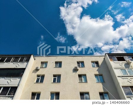 Urban apartment building with blue sky and clouds background on a sunny day Urban apartment building with blue sky and clouds background on a sunny day 140406660